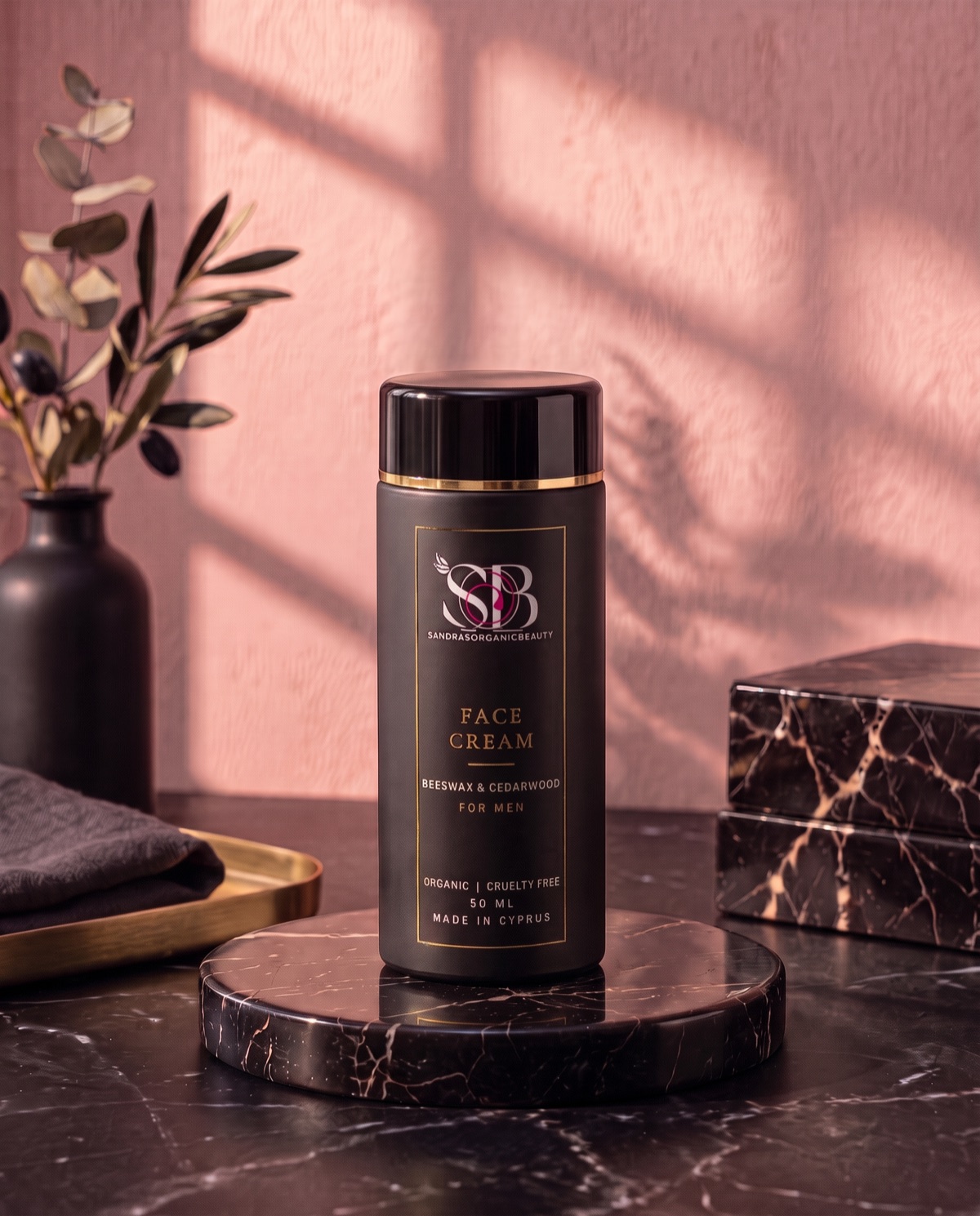 A black jar of beeswax and cedarwood face cream for men with a gold rim on a black marble stand
