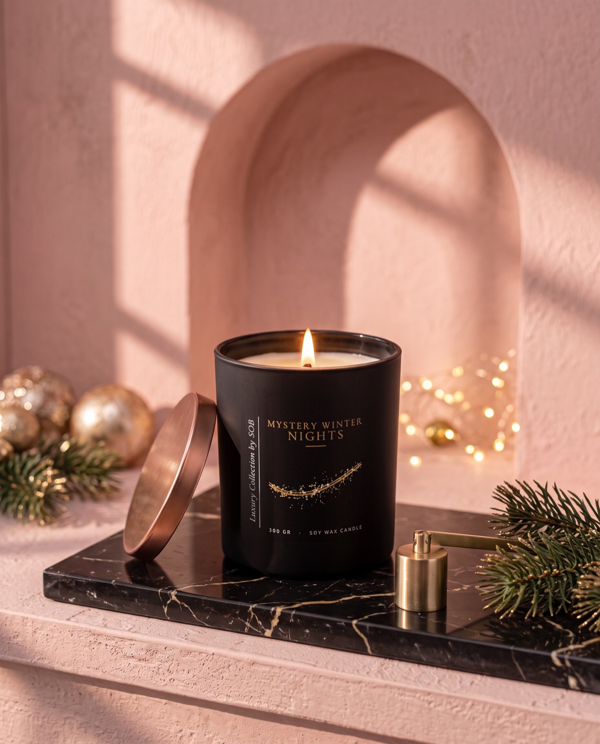 A lit candle in a matt black jar labelled Mystery Winter Nights, Luxury Collection by SOB, 300 g soy wax, with its lid, a snuffer and pine on black marble